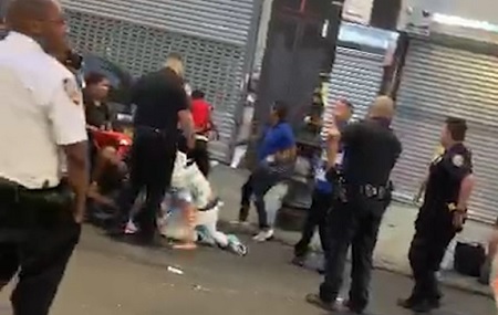 Footage shows NYPD Standing Around watching street fight.