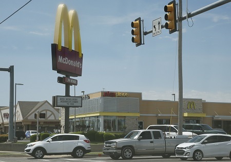 Missouri man charged for fatally shooting his friend inside a McDonald's bathroom.